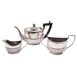 Edwardian silver three piece bachelors tea set, comprising teapot with ebonised handle and finial, twin handled sucrier, and milk jug, each of oval part fluted form, hallmarked Joseph Gloster, Birmingham 1902, (date letter to sucrier worn possibly 1901), including handle teapot H13cm, approximate total weight 14.33 ozt (445.7 grams)