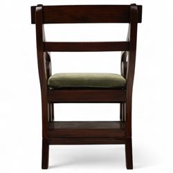 In the manner of Morgan & Sanders - early 20th century Regency design mahogany metaphoric library chair and steps, rectangular panelled top-rail with applied roundels with scrolling arms and upholstered seat and cushion, hinged and folding design transforming into four carpeted steps

Reference: The present lot is based on a design for a metamorphic library chair published by Morgan & Saunders circa 1810, P.Agius, Ackermann's Regency Furniture & Interiors, plate 29, page 60