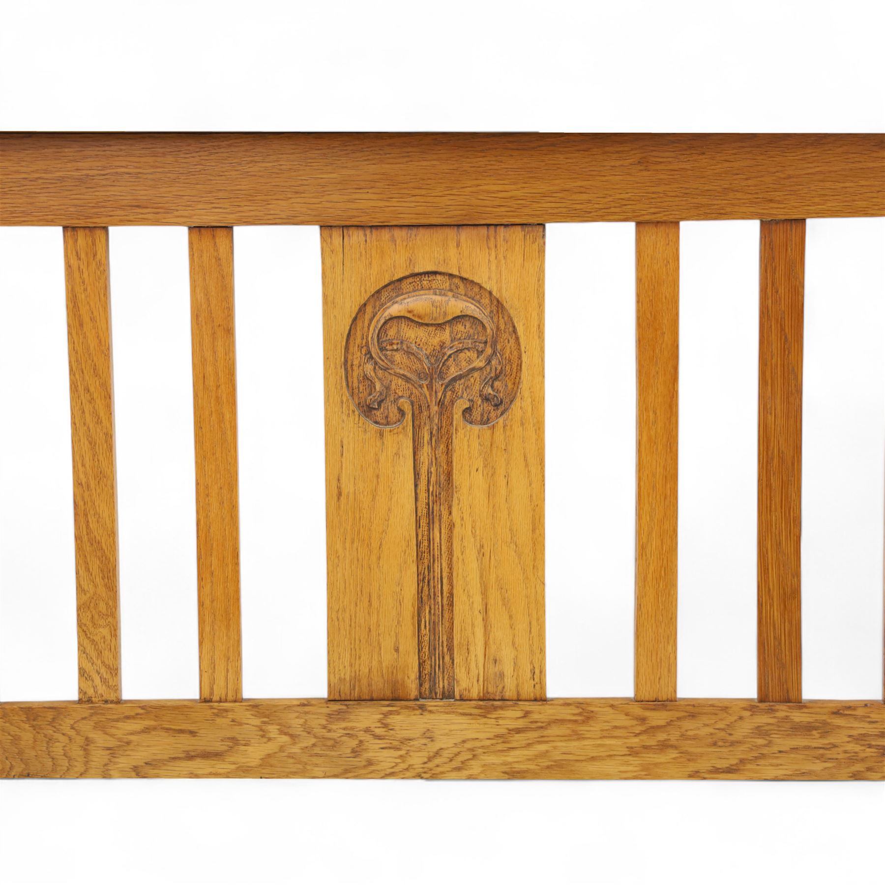 Art Nouveau oak double bed headboard, rectangular form with vertical slats centred by a carved stylised floral roundel