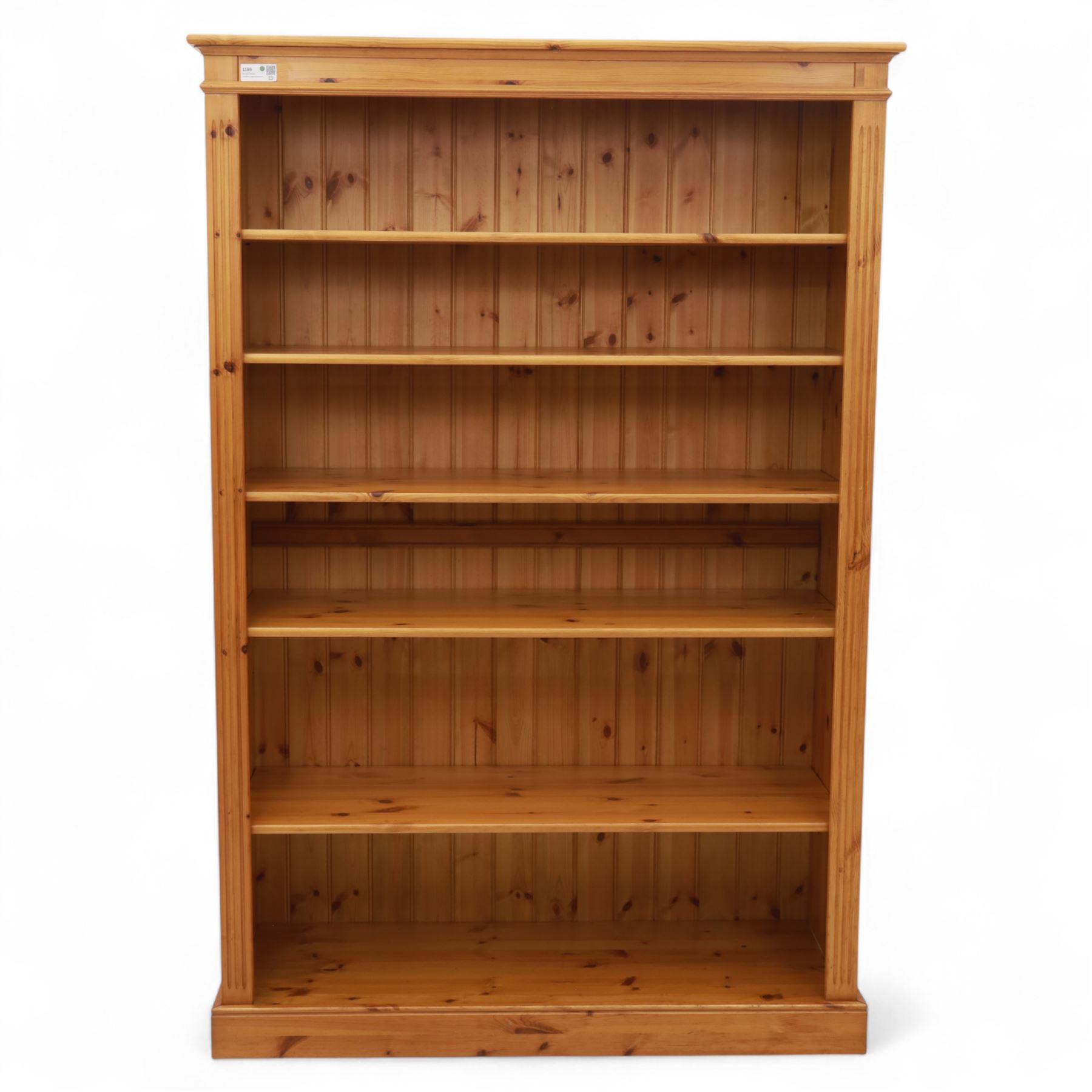 Contemporary pine open bookcase, the rectangular form with fluted uprights, tongue and groove back and five adjustable shelves