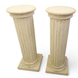 Pair of Regency style composite stone column pedestals, with fluted cylindrical columns and moulded capitals and bases, on square plinths