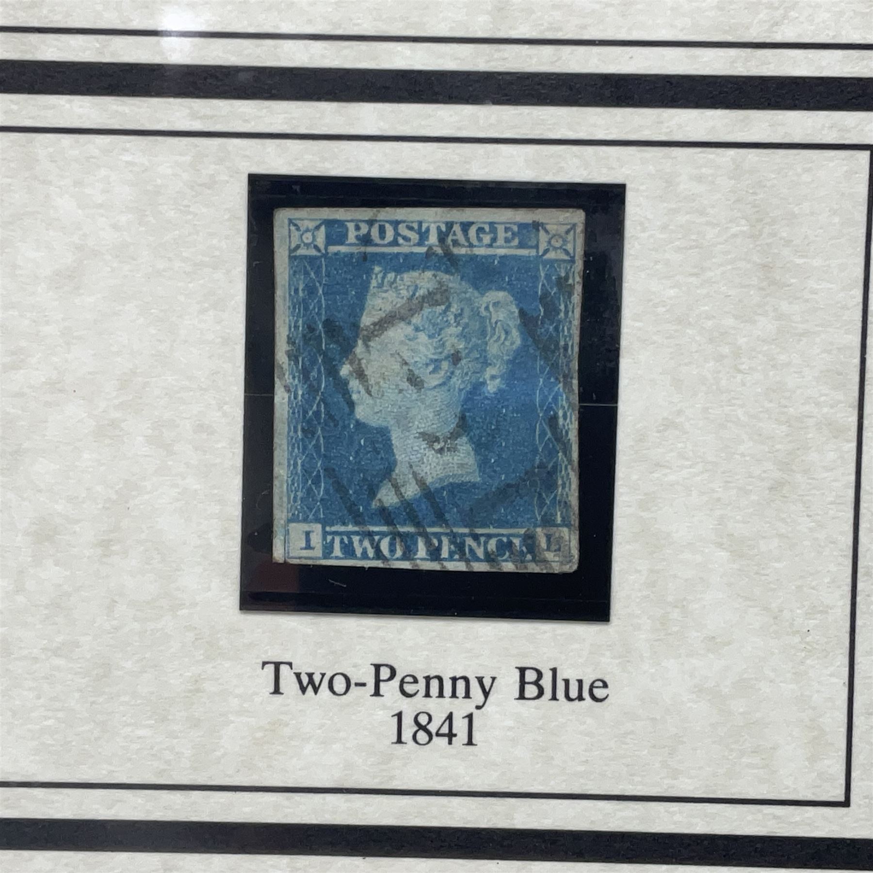Great Britain Queen Victoria penny black stamp with red MX cancel and 1841 two pence blue stamp, white lines added, with black cancel, housed in a framed display