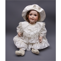 SFBJ 'Laughing Jumeau' bisque head doll with applied hair, sleeping brown eyes, open-closed mouth with teeth and tongue and composition body with jointed limbs, impressed marks 'SFBJ 236 Paris 12', H60cm  