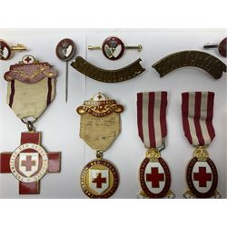 Collection of St John Ambulance enamel and metal badges, together with Red Cross medals and badges