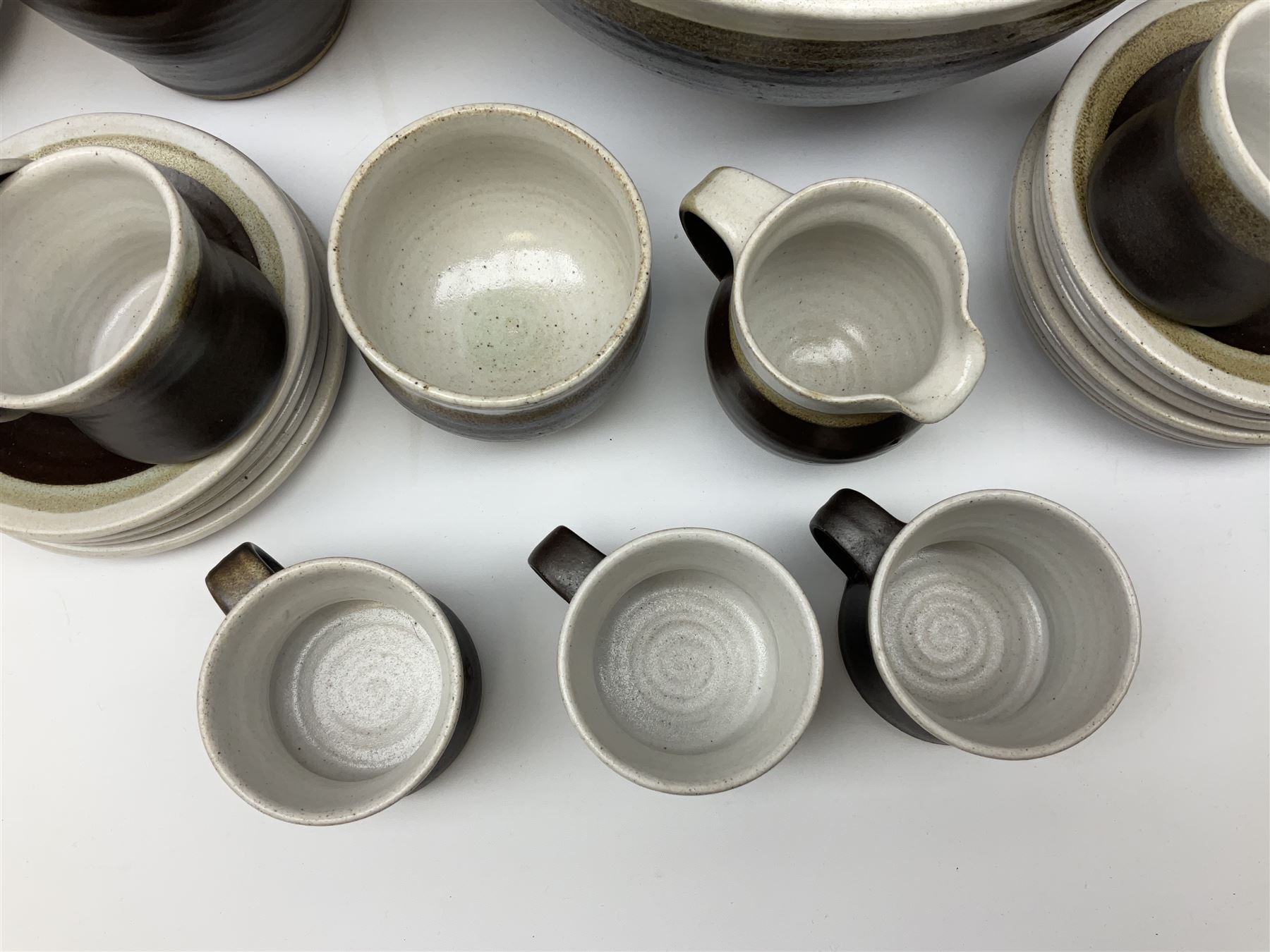 Marianne De Trey (British 1913-2016) stoneware coffee service for twelve, together with a large deep stoneware footed bowl and ladle with wood handle, all decorated in Manganese 'Pattern 1' with impressed shell marks, bowl D27cm