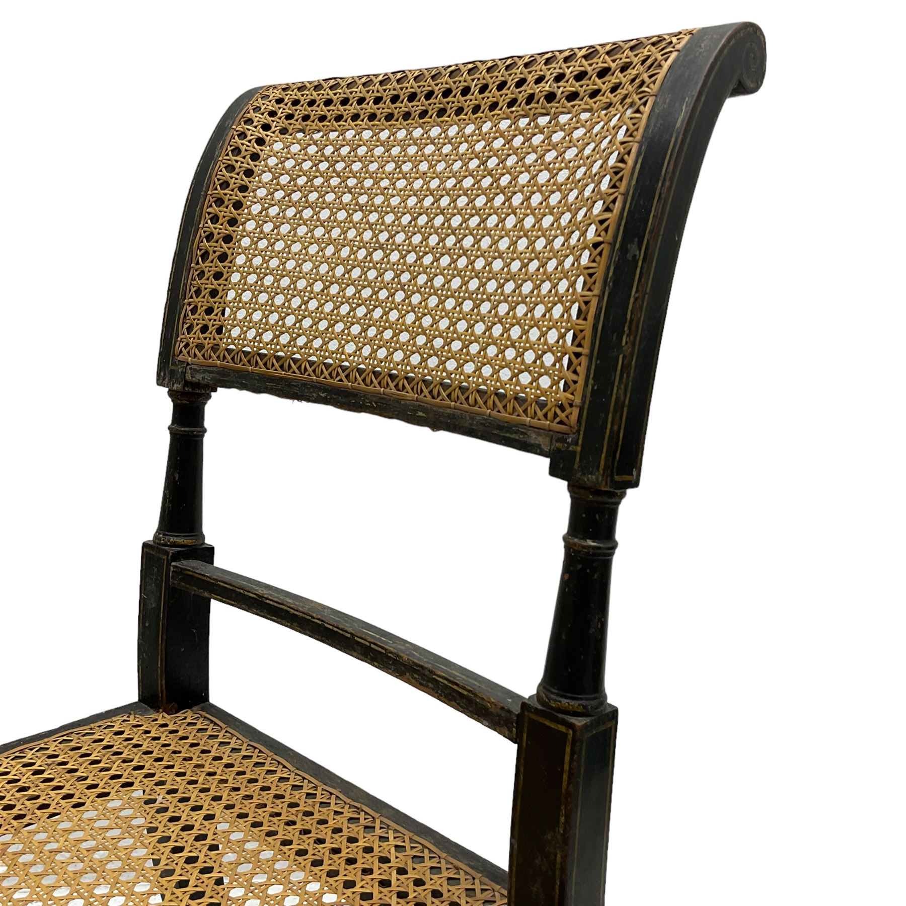 Collection of Regency dining chairs - set of four Regency painted beech dining chairs, with cane seat and back, on collar turned supports with splayed feet (W46cm, H84cm); a pair of Regency ebonised dining chairs (W47cm, H77cm); and a single Regency dining chair, the cresting rail painted with floral cornucopias and central putto vignette, X-frame back over cane seat, on collar turned front supports painted with foliage (W46cm, H84cm) (7)