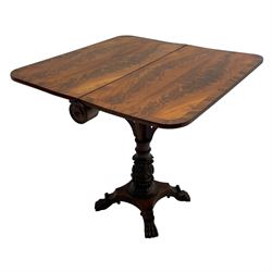 Unusual William IV mahogany Sutherland table, figured and book-matched rectangular drop-leaf top on cylindrical barrel movement, turned roundels to each end, on turned pedestal with acanthus carved baluster, shaped platform with four extended paw feet