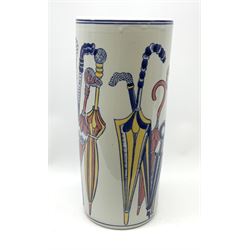 An umbrella stand decorated with umbrellas in blue, yellow and pink upon a white glazed ground, H44cm.