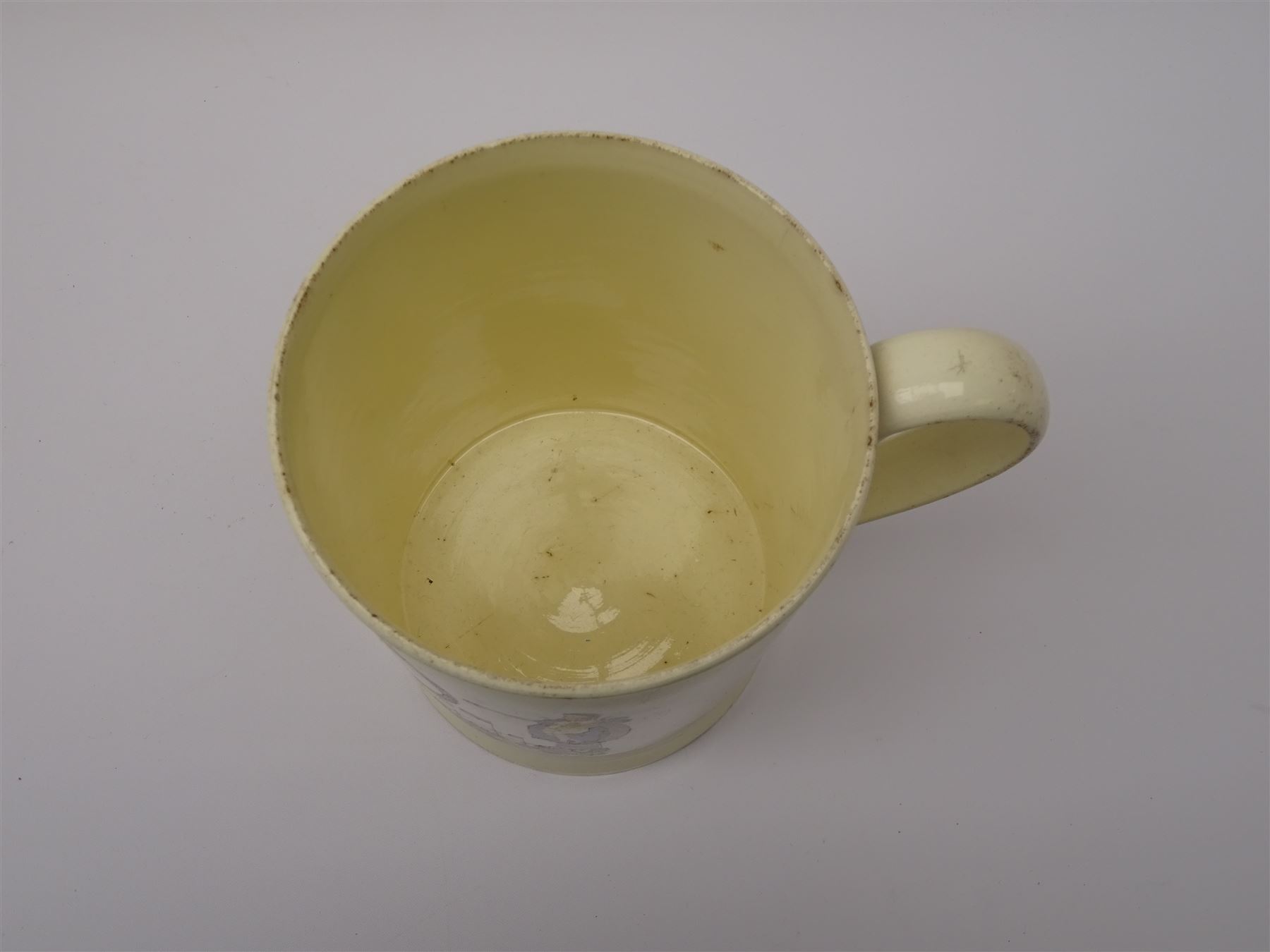 Early 19th century Sunderland Dawson & Co creamware pottery mug, the cylindrical body black transfer printed and polychrome detailed with a circular panel of a three-masted ship flanked by two figures of Peace and Plenty, above a panel containing verse 'May Peace with Plenty on our Nation smile [...]' H15cm D11cm