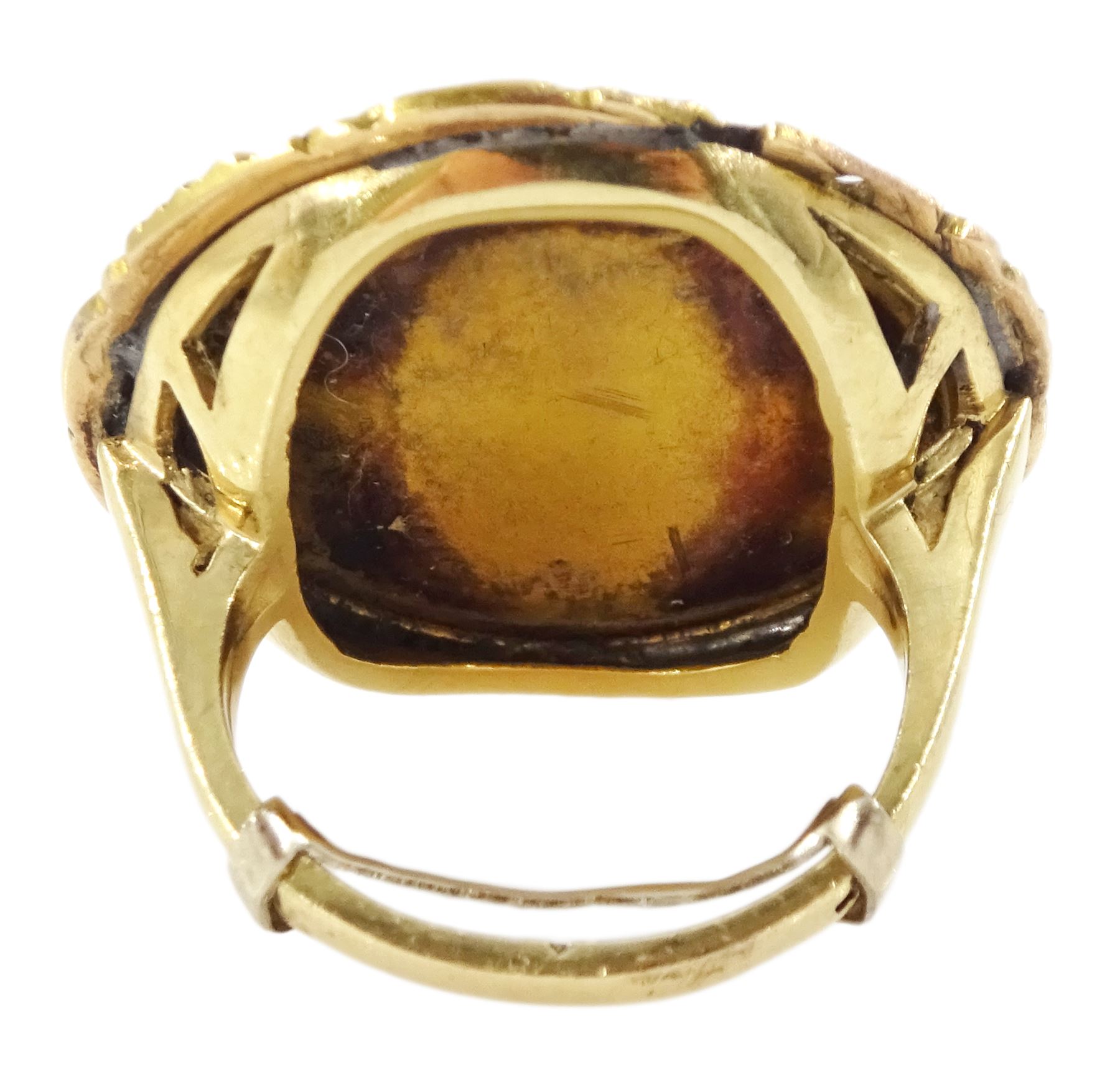 19th century gold portrait ring, set with a circular miniature of a young woman in 18th century dress on ivory, under a glazed panel, within a gold scroll frame and pierced gallery. This lot has been registered for sale under Section 10 of the APHA Ivory Act