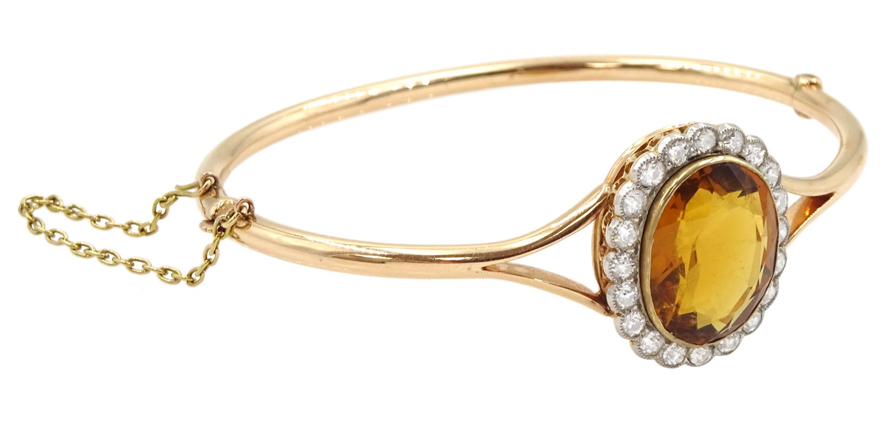 Early 20th century 15ct rose gold oval citrine and milgrain set old cut diamond hinged bangle, total diamond weight approx 1.10 carat