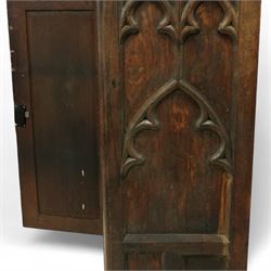 19th century Gothic Revival oak Sacristy vestment cupboard of tall proportions, fitted with two ecclesiastical trefoil moulded panelled doors enclosing four shelves, flanked by a chamfered corner, the side panelled and moulded with matching sacristic architectural mouldings, on skirted base