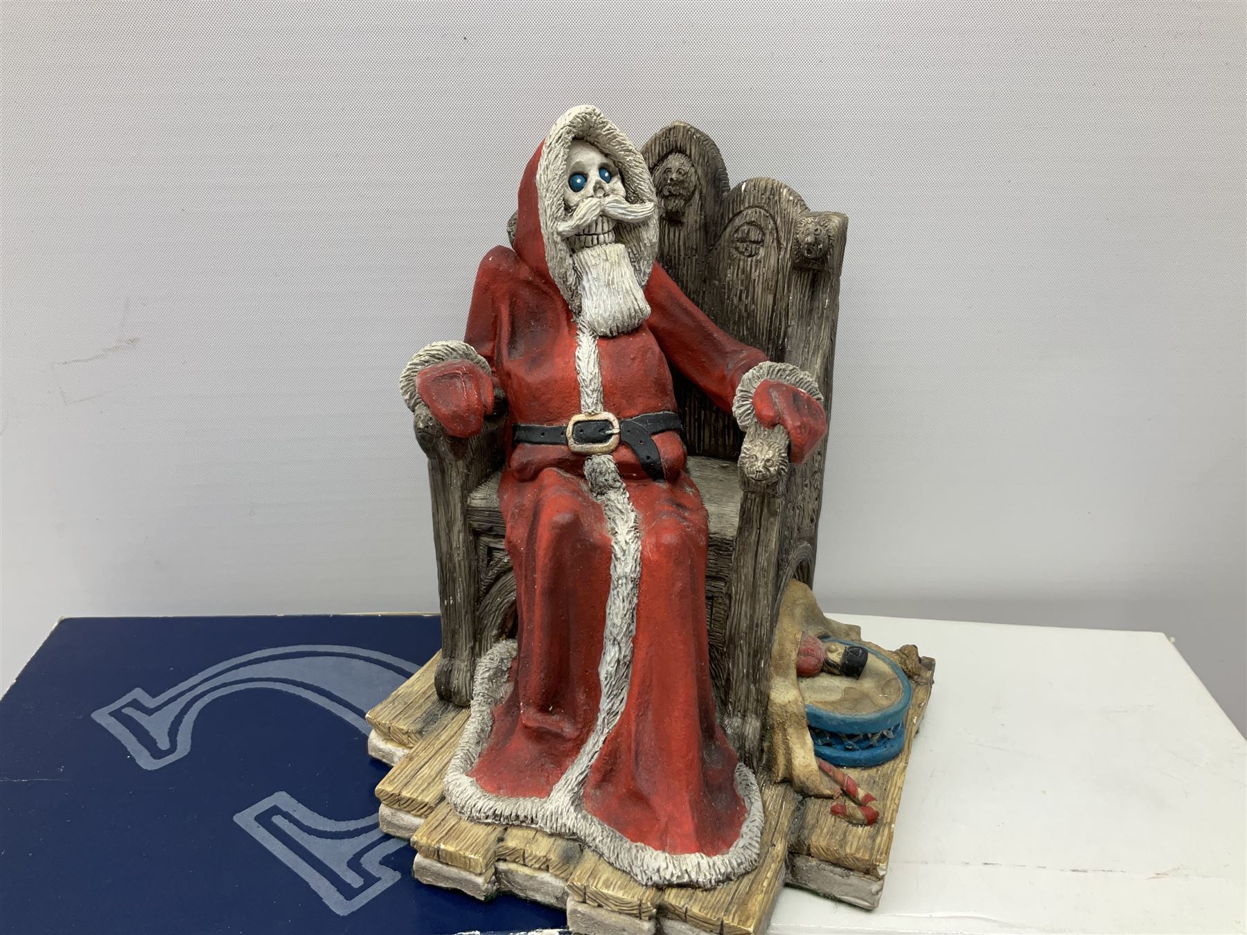 Terry Pratchett Discworld figures, designed by Clarecraft, comprising Lias Bluestone DW82, Hogfather DW72, Granny Weatherwax, boxed, DW06, Ridcully DW61and 'Ironcrust's genuine dwarf bread'.