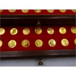 Danbury Mint, Our Royal Sovereigns Collection, seventy 22 carat gold plated silver medallions depicting the complete line of British monarchs to mark the 1200th anniversary of the first coronation, contained within wooden table top collectors cabinet with two drawers, with certificate of authenticity, with two drawers, hallmarked Danbury Mint, London various dates