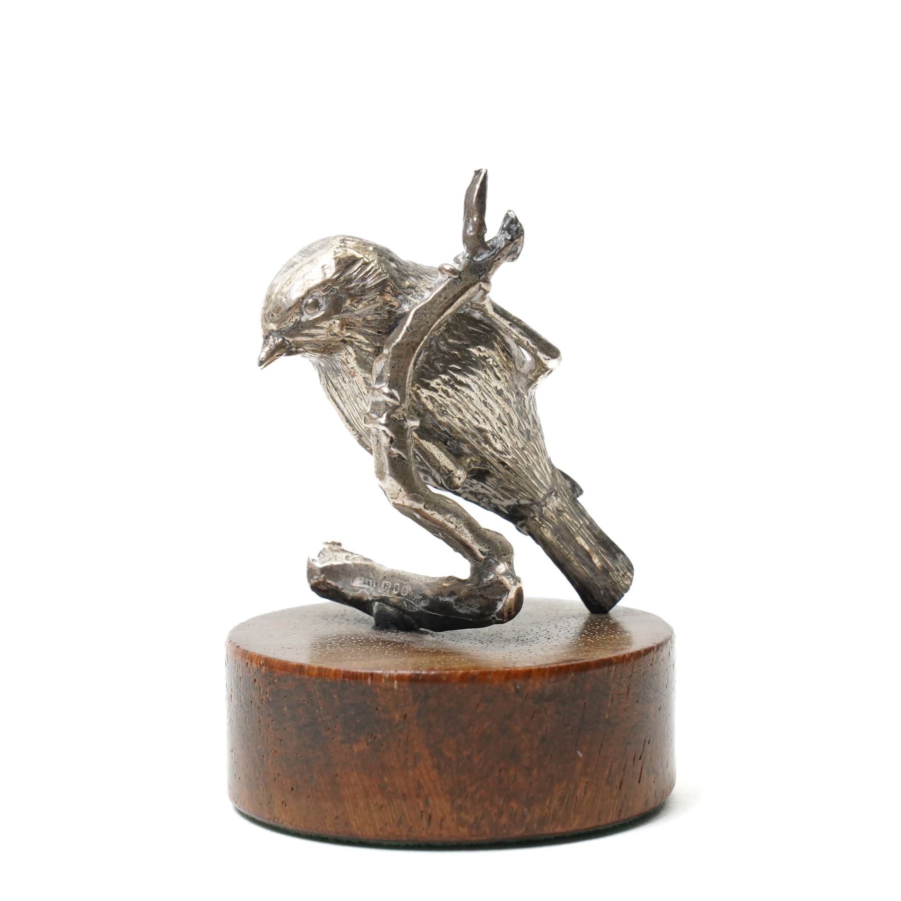 Silver model of a bird perched on a branch and with wooden base by Goldsmiths and Silversmiths Co. H5cm, small silver model of a pheasant on wooden base H2.5cm and a silver miniature model of a dog in a basket marked 925 and indistinct maker's mark L3.5cm (3)