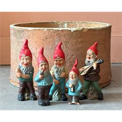 Group of painted terracotta garden gnomes, (5) together with a broken terracotta planter /...
