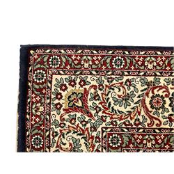 Persian design crimson ground carpet, the central rosette medallion surrounded by scrolling leaves and flower heads, the spandrels decorated with floral design and scrolling foliage, repeating border within guard stripes