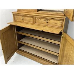 Early to mid-20th century light oak secretaire office cabinet, cupboard enclosed by two panelled doors over two drawers and slide, the lower section fitted with two shelves and enclosed by two panelled doors