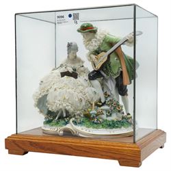 Unterweissbach style porcelain figural group of a seated lady with a gentleman playing a lute, stamped 'Foreign' to base, in bespoke display case