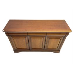 Cherry wood sideboard, fitted with three cushion drawers over three panelled cupboard doors, on bracket feet