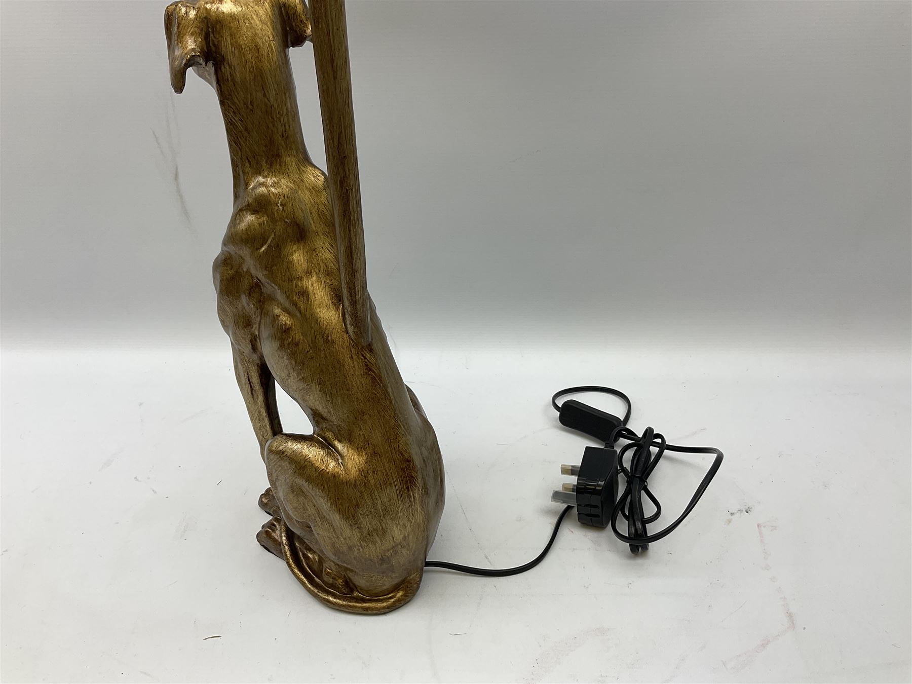 Composite table lamp, modelled as a gilt seated whippet, with teal velvet shade, H71cm
