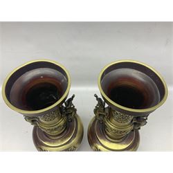 Pair of oriental twin handled brass vases decorated with stylised dragons, together with a brass tureen with central chimney, the ring shaped lift off lid decorated with band of dragons and key fret border, tallest H35cm
