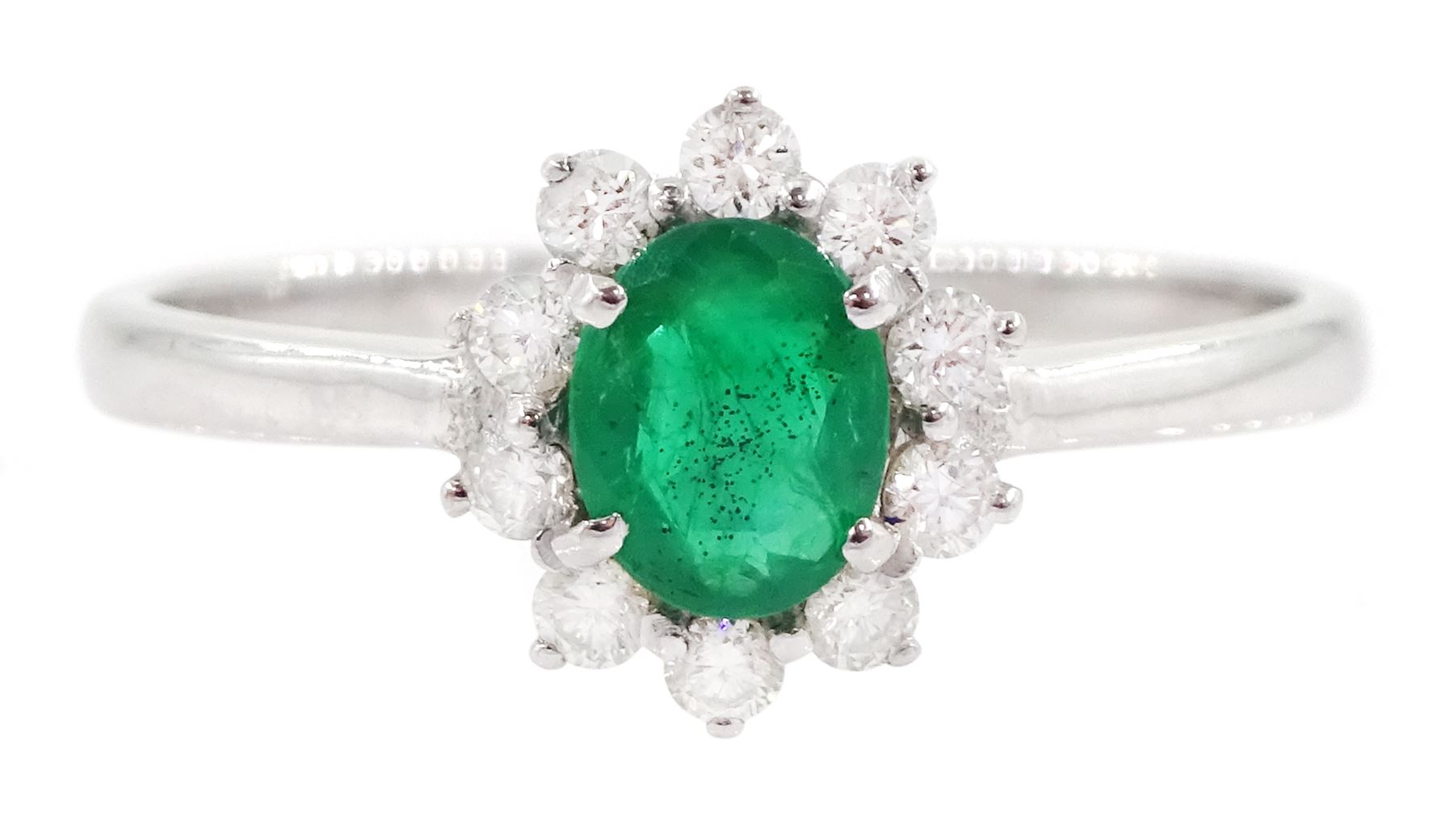 18ct white gold oval cut emerald and round brilliant cut diamond cluster ring, stamped 750