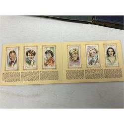 Three albums of cigarette cards including Wills Recruiting Posters, Military Motors and Allied Army Leaders, cricketers etc; another album containing a large quantity of laid-in cigarette cards; and an album of thirty-seven postcards of dogs by Mac (5)