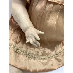 German bisque head doll with applied hair, sleeping eyes and open mouth with teeth and fixed tongue, on composition body with jointed limbs, marked 'P.M. 914 Germany 14' H65cm