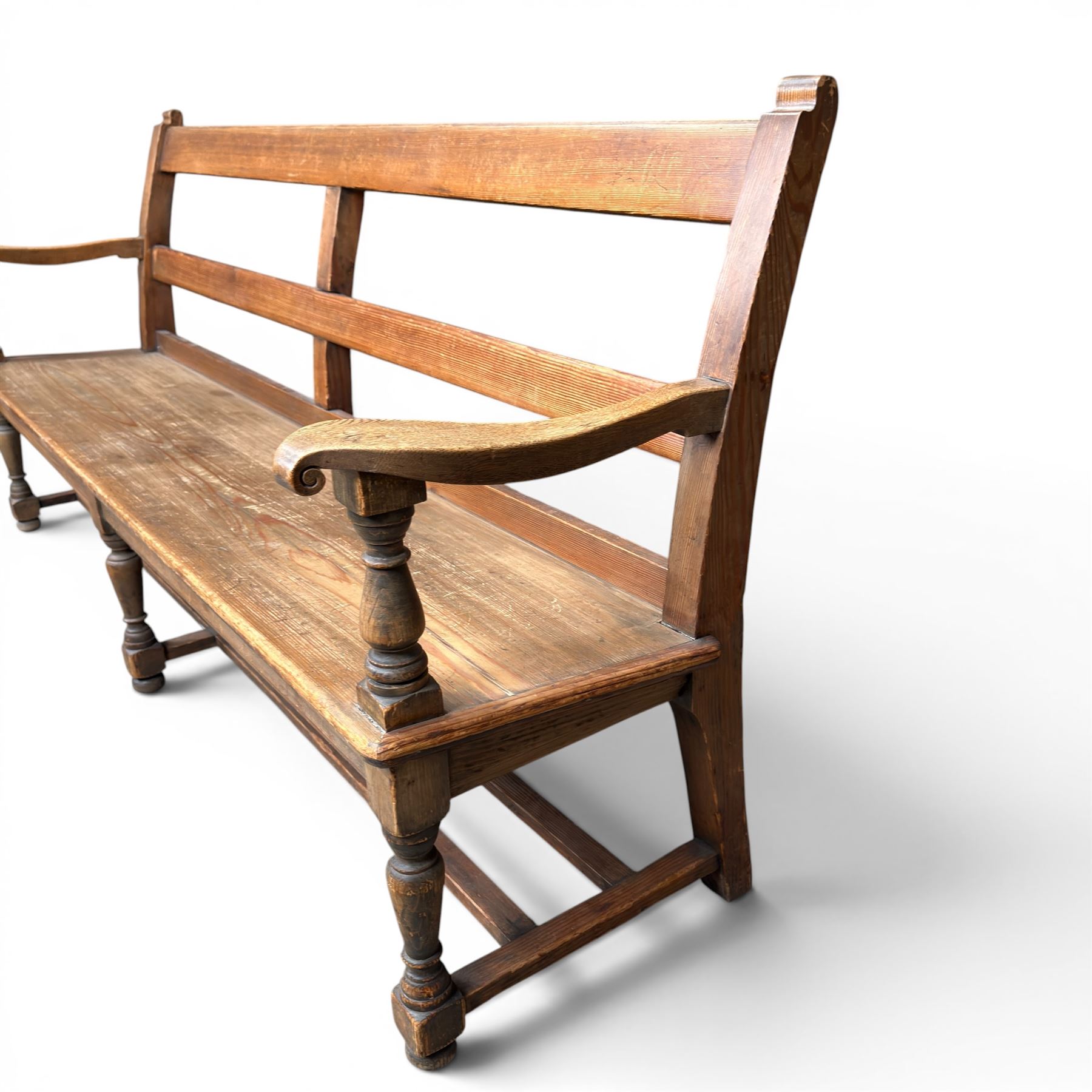 Early 20th century pine and oak bench seat, stained pine rail back frame with shaped oak arms
