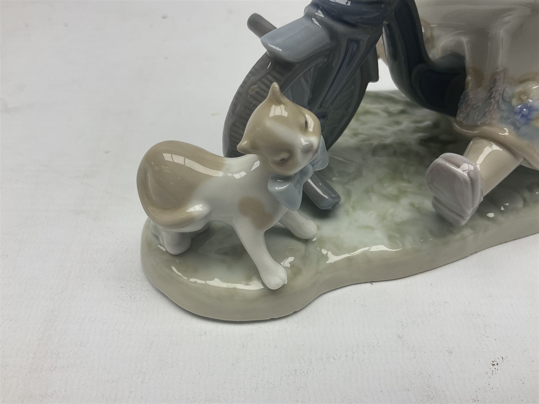 Lladro figure, In No Hurry, modelled as a girl on a tricycle, sculpted by Francisco Polope, with original box, no 5679, year issued 1990, year retired 1994, H15cm