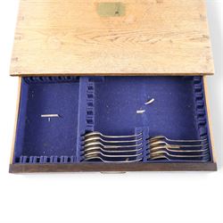 Ealy 20th century oak canteen, with five drawers behind double doors, four drawers containing a part set of silver plated Hanoverian pattern cutlery with engraved monograms and a set of twelve mother of pearl handled fruit knives and forks, the last drawer containing a collection of loose silver plated cutlery, canteen H39cm, W48cm