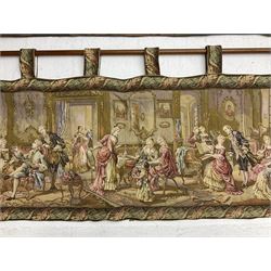 Two tapestry style panels, the first depicting Georgian scene of a gentleman serenading two ladies with a lute in a garden setting, together with a further example depicting a soiree scene with well dressed ladies and gentlemen within a foliate border, both suspended from wood poles and lined, widest W140cm H65cm