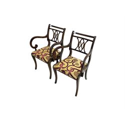 Regency design mahogany twin pedestal dining table, rectangular top with reeded edge, acanthus carved turned column terminating in reeded tripod base with hairy paw feet and castors (W172cm D92cm H75cm) and set eight (6+2) Regency design mahogany dining chairs, pierced back with scroll design, seat upholstered in patterned laurel green fabric, raised on reeded sabre supports (W48cm H88cm)