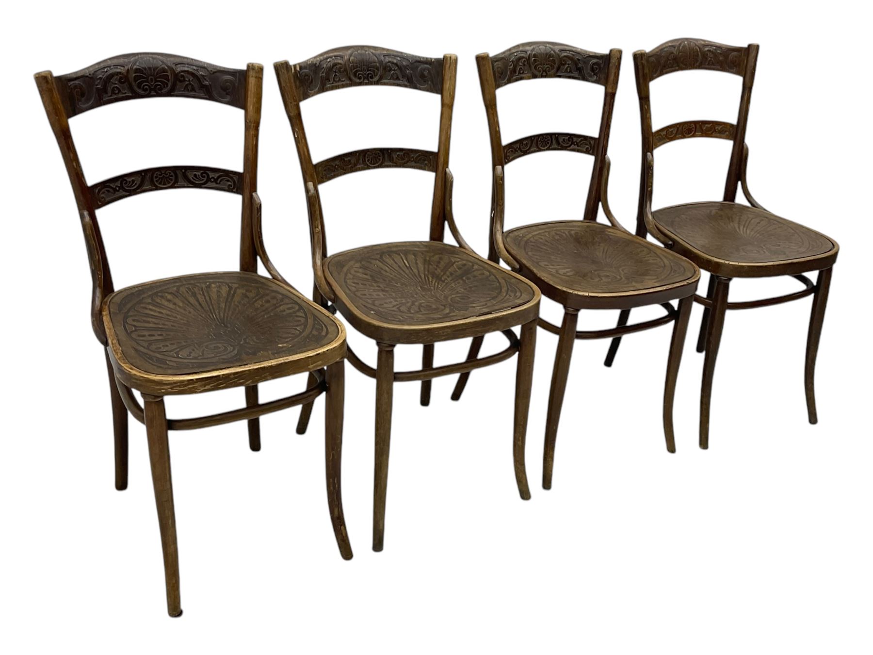 Jacob & Josef Kohn - set of four early 20th century Austrian bentwood chairs, each with carved decoration to the shaped backrest and shaped seat, on splayed supports with stretchers, marked with the manufacturer's stamp and paper label beneath