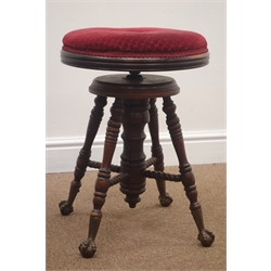  19th century adjustable piano stool, upholstered seat, turned supports joined by stretchers on cast iron ball and ball and claw feet, 37cm diam  