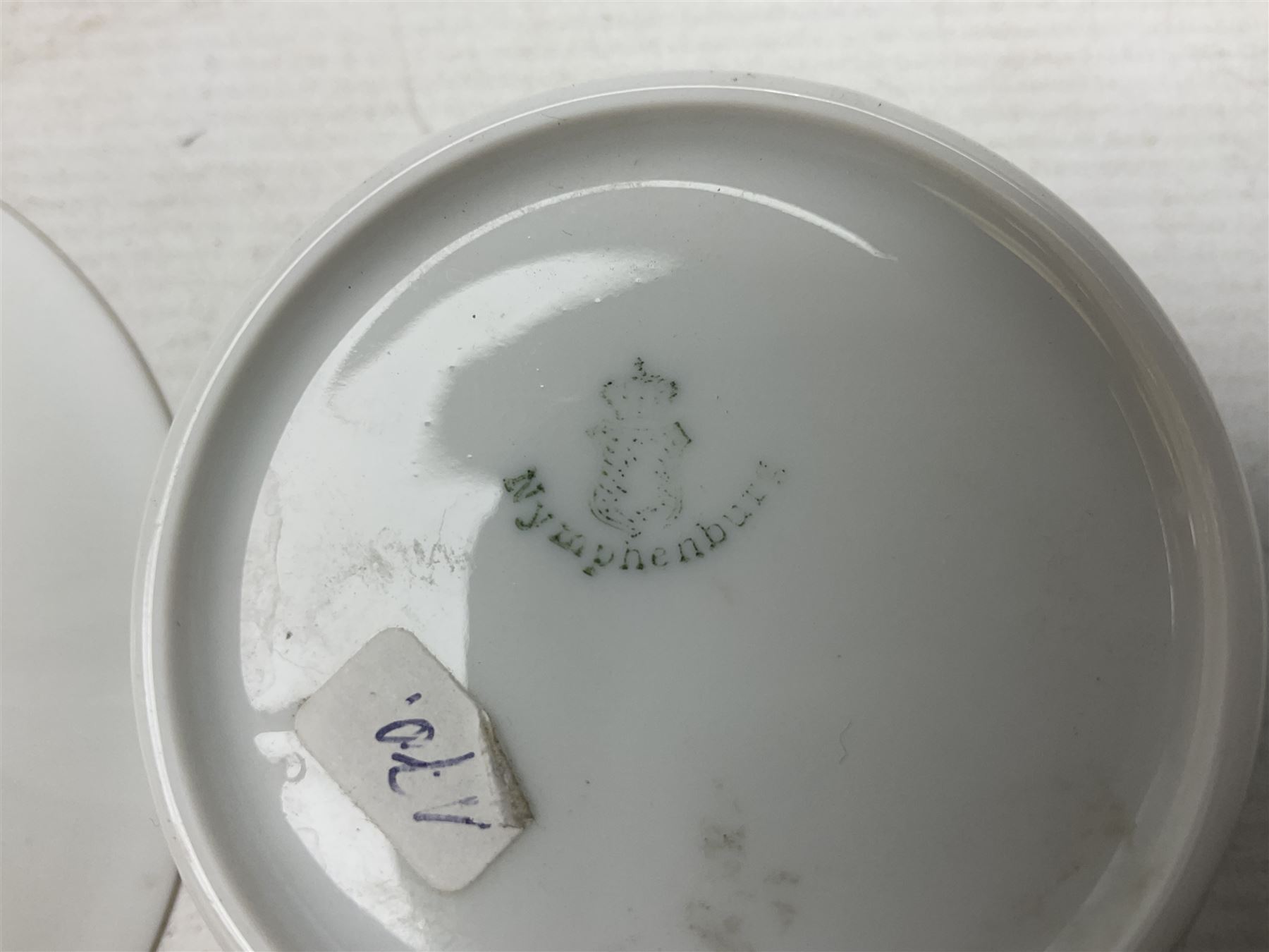 WW2 Nymphenburg cups and saucer, decorated with Imperial German Iron Cross encircled in a foliate boarder with gilt edging, with printed mark beneath 