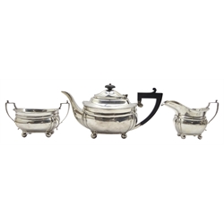  Silver three piece tea set of oblong form with gadrooned border, the teapot with ebonised handle and lift by Thomas Edward Atkins Birmingham 1915 19.1oz  