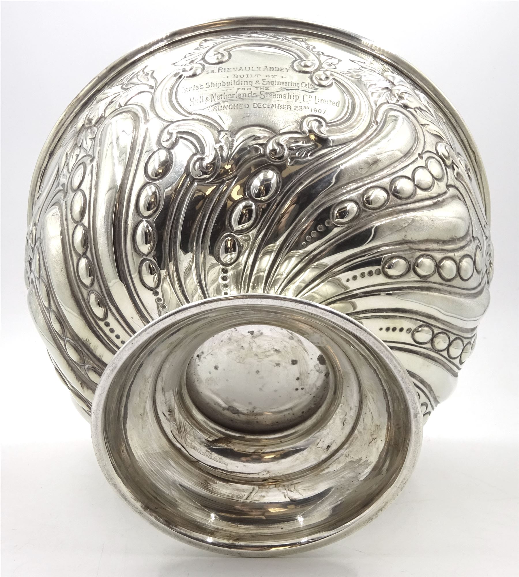 Edwardian silver rose bowl, the part fluted bowl embossed with acanthus leaves, flower heads and C scrolls and personally engraving 'S.S Rievaulx Abbey - Built By - Earle's Shipbuilding & Engineering Co Ltd - For The - Hull & Netherlands Steamship Co. Limited Launched December 23rd 1907', upon a spreading circular foot, hallmarked F Boyton & Co, London 1905, H14.5cm, D20.5cm, approximate weight 17.34 ozt (539.6 grams)