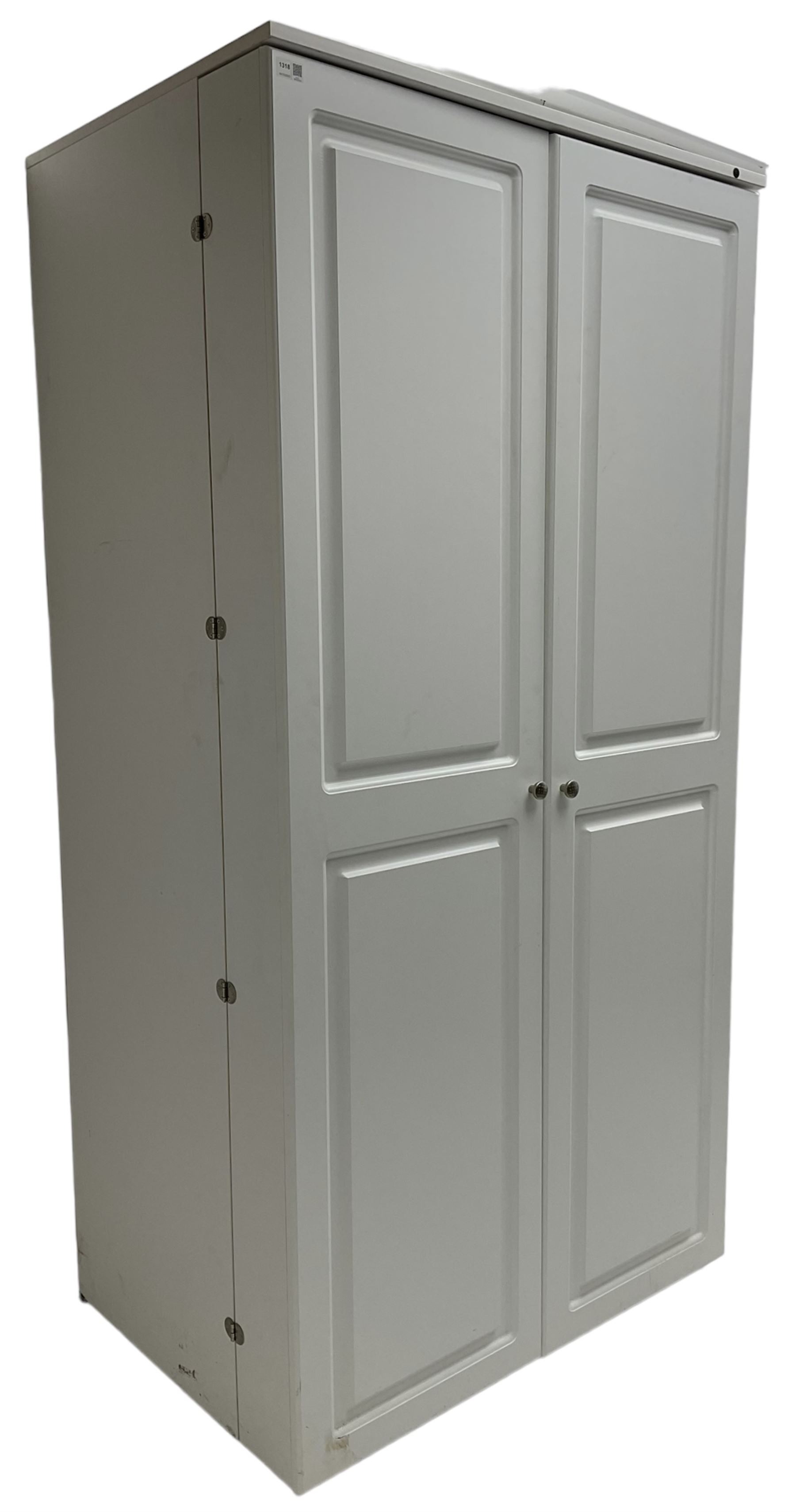 Large white finish sewing cabinet, enclosed by two doors fitted with thread holders and shelves, the interior fitted with shelves and sliding trays, with fold down work surfaces 