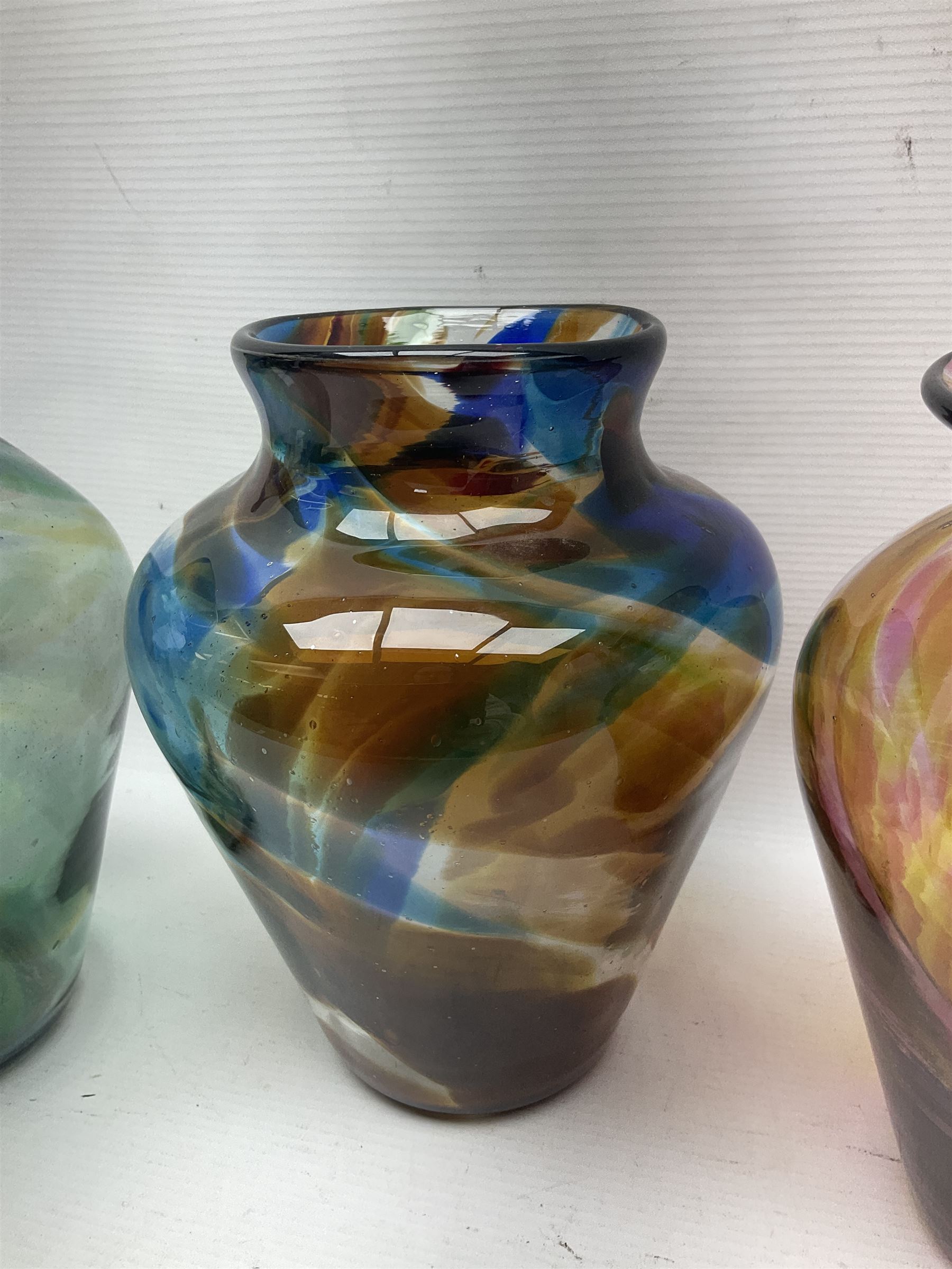 Three Hartley Wood coloured glass vases, each of baluster form with swirling decoration, tallest H21cm