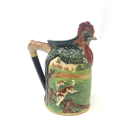  A limited edition Royal Doulton loving cup Master of the Fox Hounds M.F.H. presentation jug, the rim modelled as the head of a cockrell, the body with raised decoration depicting hounds in chase, no 325/500, with printed marks to base, (a/f), H33cm.   