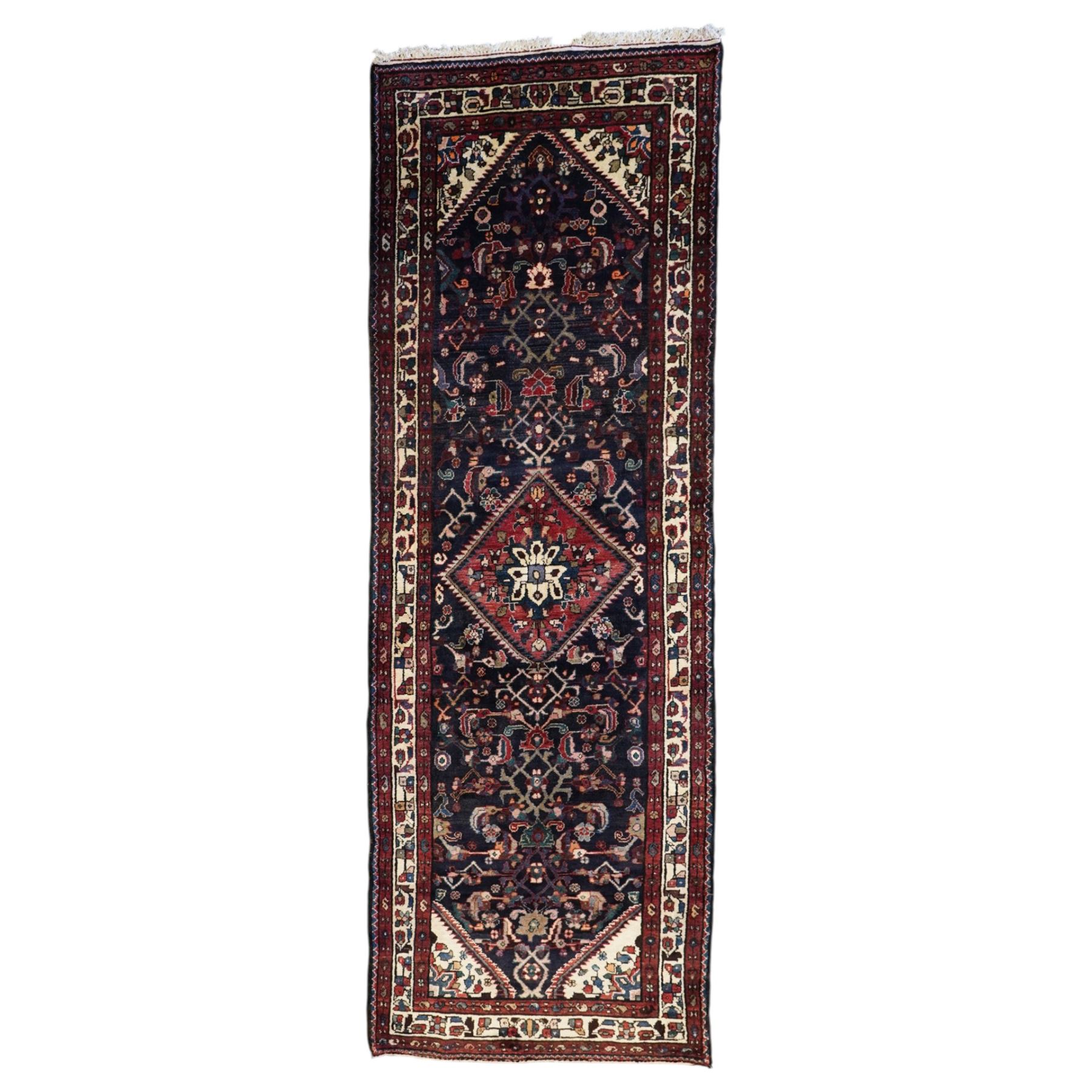 North West Persian Hamadan hand-knotted runner, indigo field with an all-over herati inspired lattice issuing from a central axis with stylized palmettes, rosettes and angular vinery, enclosed by stepped triangular spandrels with ivory reserves, broad ivory main border of stylized flowers and geometric devices, flanked by reciprocal guard stripes, cotton fringe ends 