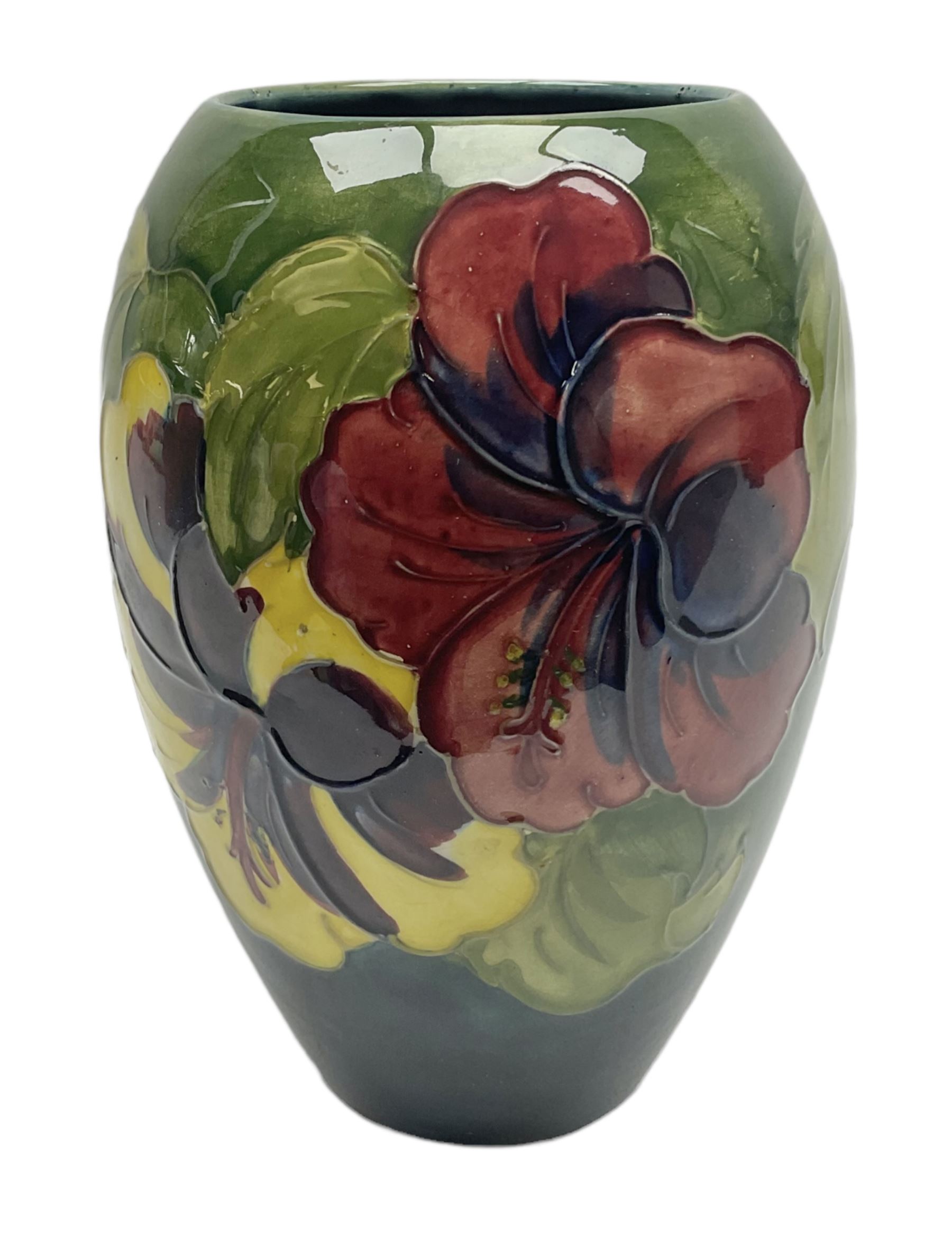 Moorcroft Hibiscus pattern vase of ovoid form, decorated with pink, yellow and purple flowers on merging blue and green vase, with impressed and painted marks beneath, H18cm