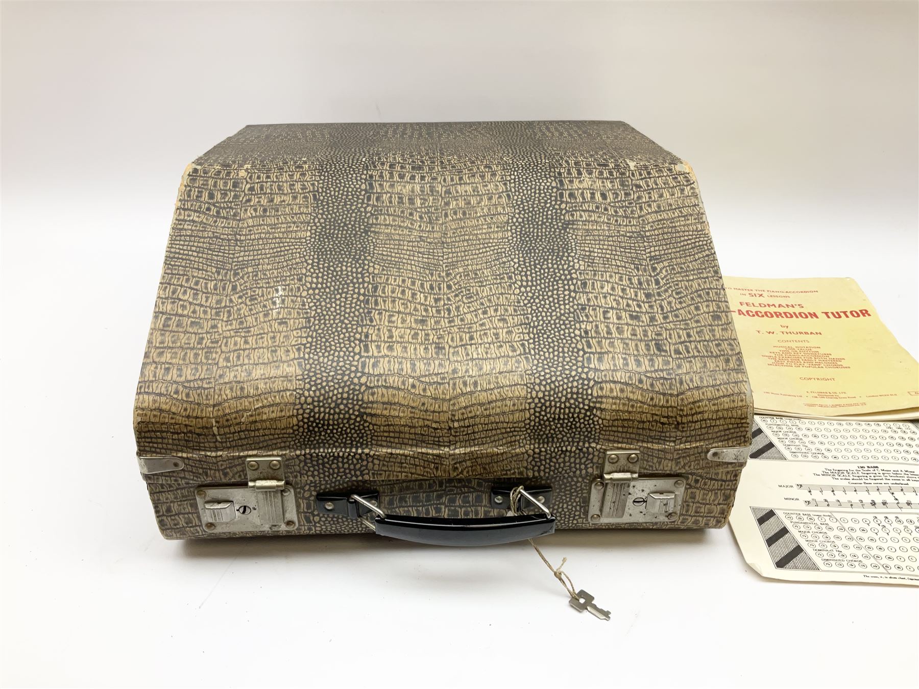 GDR Firotti piano accordion with black and silver case, sixteen keys and forty-eight buttons L38cm; in simulated reptile skin case with sheet music