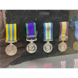 Limited edition large framed display board with sixty half-size copies of British Gallantry and Campaign Medals produced by Danbury Mint; all with ribbons and associated booklet