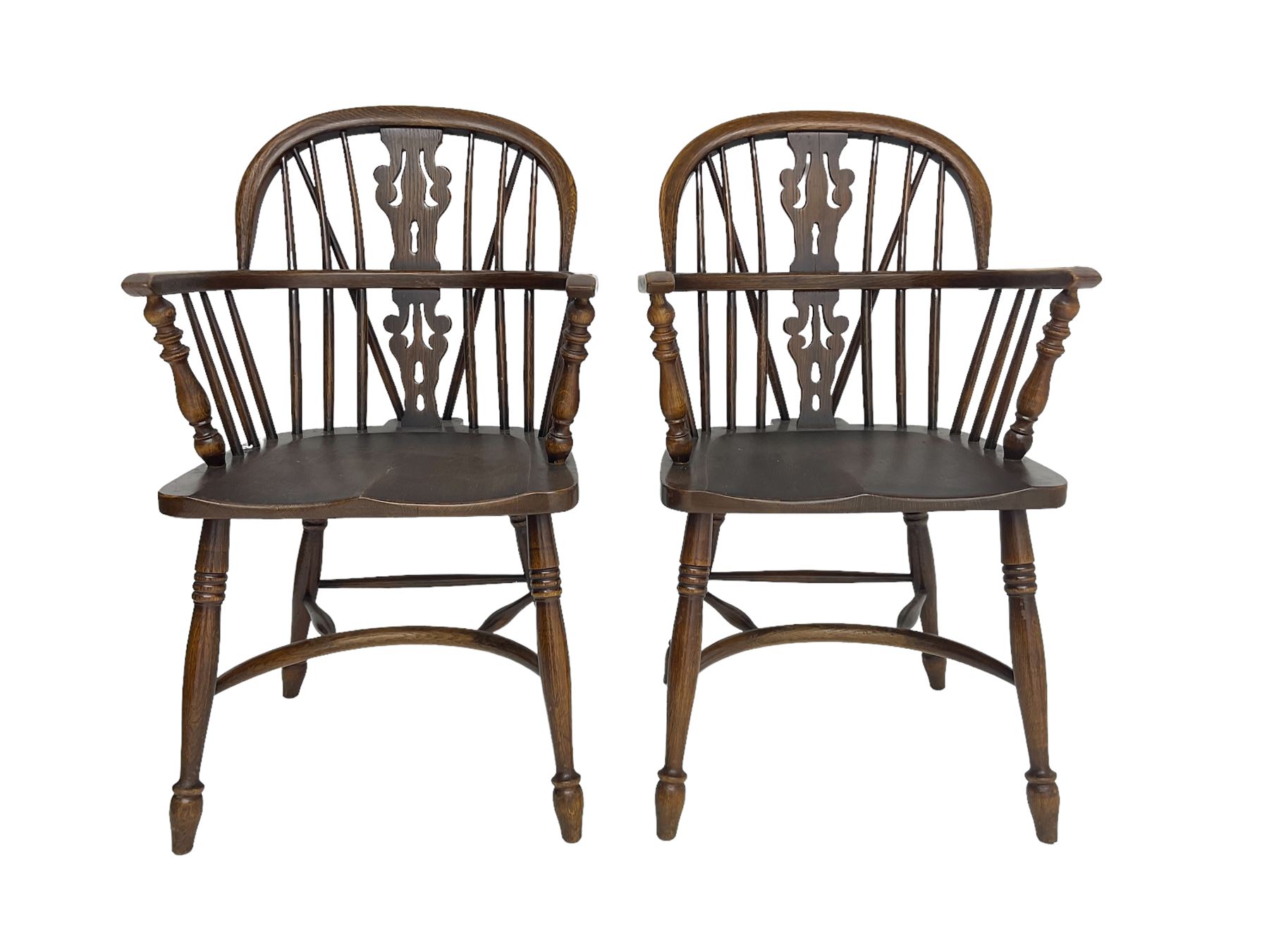 Pair late 20th century oak Windsor elbow chairs, double hoop and stick back with pierced and fretwork work splat, dished seat on turned supports joined by crinoline stretcher