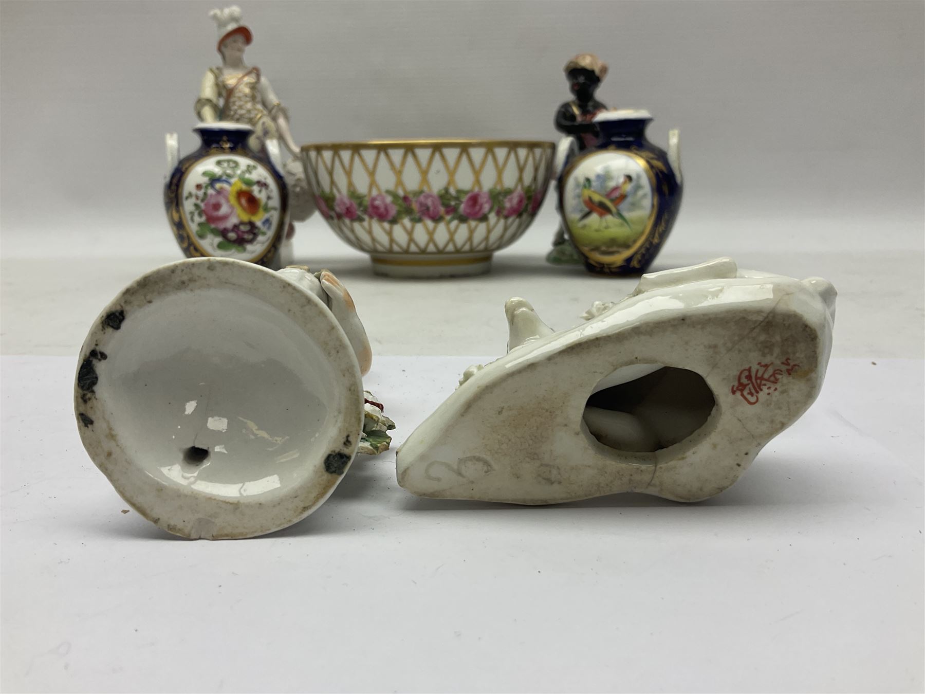 Group of 18th and 19th century ceramics for repair and restoration, to include an 18th century Derby figure emblematic of the Continent of Africa, pair of small 19th century Derby vases, painted with birds and floral spray, 19th century Derby slop bowl decorated in the 594 pattern with pink roses against gilt trellis, 19th century Derby figure of a recumbent deer, Serves style box, and two further figures