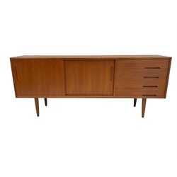 Nils Jonsson - mid-20th century teak sideboard, rectangular top over three-section base, left and centre sections with sliding double doors enclosing shelving, right section with four drawers, raised on tapered supports