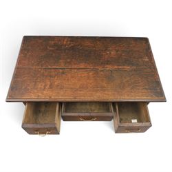 18th century oak lowboy, rectangular plank top with moulded edge, above three assorted drawers with brass swan neck handles, shaped apron raised on pad feet